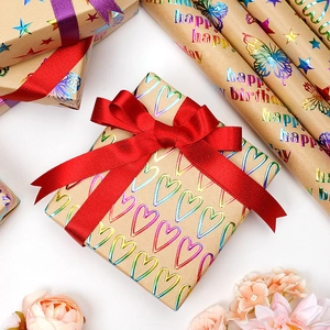 Heart and star pattern laser kraft gift wrapping paper with red and purple ribbons