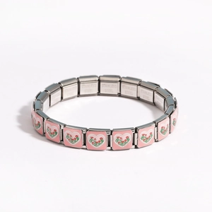 Close-up of stainless steel charm links with pink heart and red flower patterns