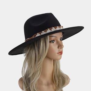 Detail of classic black wool felt fedora featuring a woven brown and white decorative band