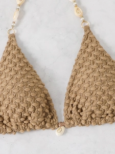 Detail of khaki seersucker bikini top with natural seashells and gold bead decorations