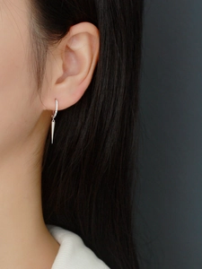 Close-up of S925 silver hoop earring with pavé stones and geometric spike pendant