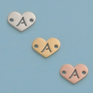 Polished heart-shaped charms with cutout letter A in silver, gold and rose gold finishes