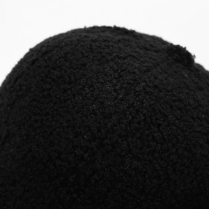 Close-up of the soft black sherpa fleece texture on a warm winter baseball cap
