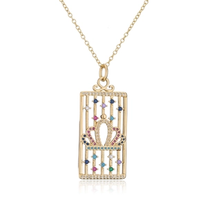 Detailed close-up of 18K gold-plated birdcage pendant with a colorful zircon crown
