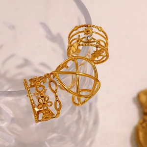 Three-piece stackable 18K gold-plated open rings with floral, geometric, and star charm designs