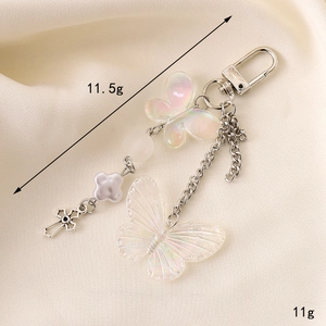 Iridescent acrylic butterfly keychain with silver metal cross and lobster clasp charms