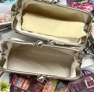 Detailed view of vintage oil painting coin purse with silver ball clasp and lining