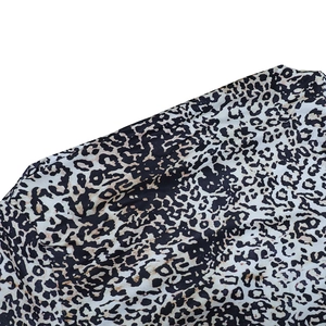 Close-up macro of the leopard print fabric texture on this slim-fit off-shoulder dress