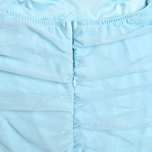 Detail of light blue glitter fabric with ruching and hidden back zipper closure