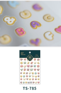 Macro detail of 3D macaron candy color alphabet nail stickers with relief texture
