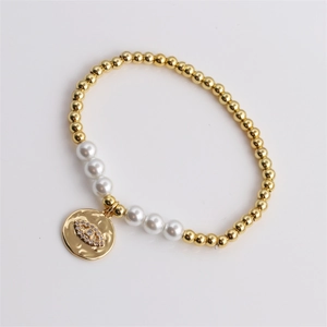 Bracciale elastico con perline dorate, perle bianche e ciondolo a forma di occhio di Allah