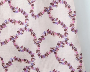 Close-up of floral pattern fabric with purple and pink wavy prints for slim maxi dress