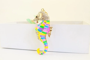 Detailed close-up of a colorful seahorse keychain with sparkling rhinestones and enamel