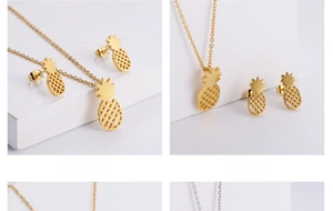 Detailed view of gold pineapple jewelry set with hollow mesh texture on stone background