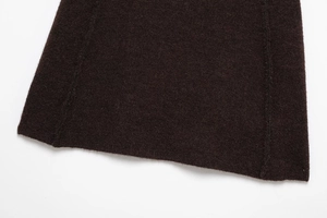 Close-up of high-quality dark brown knit fabric with precise hem stitching details