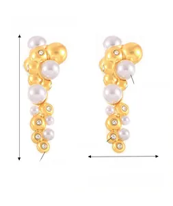 Detailed view of gold titanium steel earrings with imitation pearls and Czech diamonds