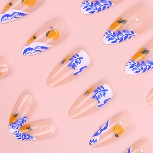 Long almond press-on nails with orange peach fruit patterns and blue wavy lines on pink base