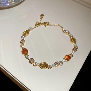Detailed view of luxury butterfly gold bracelet featuring colorful gems and sparkling zircon