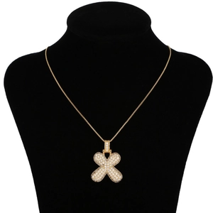 Detail of hip hop gold letter X pendant with micro-pave zircons on a box chain