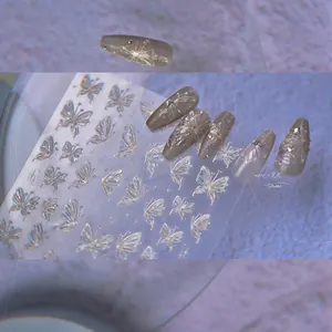 Macro shot of 3D iridescent laser butterfly nail stickers with embossed relief effect