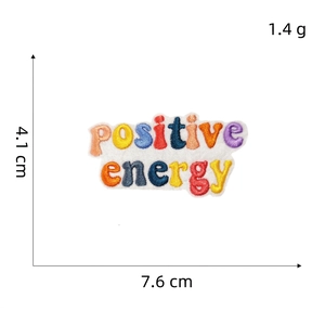 Detailed view of positive energy embroidered patch with 7.6cm width and 4.1cm height