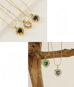 Detailed view of heart-shaped zircon necklaces in multiple colors on gold stainless steel
