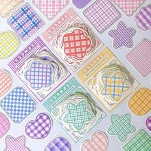 Detailed view of pastel plaid macaron colored stickers in heart and star shapes