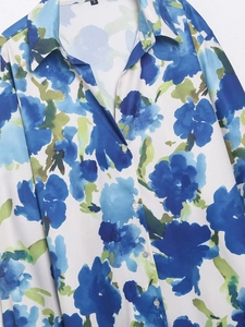 Détail du col de chemise en satin imprimé floral avec bouton blanc classique
