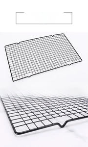 Close-up of black carbon steel baking cooling rack with non-stick grid and support feet