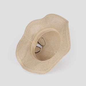 Detail of summer straw sun hat interior with sweatband and black elastic windproof cord