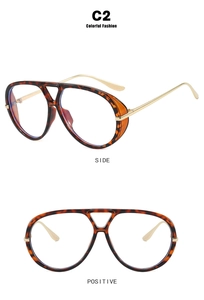Detail of tortoise pilot glasses frame with gold temples and side shield protection