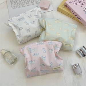 Detailed flat lay of fabric cosmetic bags with cute cat patterns in three colors