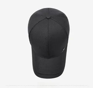 Top down view of black twill cotton baseball cap showing silver metal letter logo detail