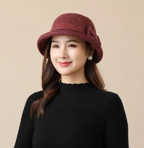 Detail of red and black houndstooth pattern on a vintage wool-style bucket hat for women