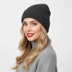 Close-up of dark grey waffle knit beanie showing thick texture and warmth on model
