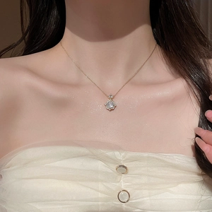 Close-up of 14k gold plated rose pendant necklace with zircons on a female model
