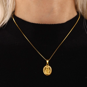 Gold Virgin Mary oval pendant necklace with box chain on model over black background