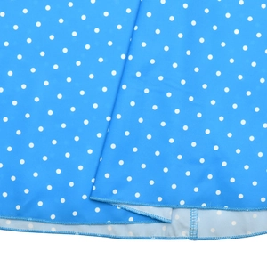 Detailed view of the blue fabric with white polka dots and high-quality stitching detail
