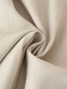 Macro shot of the beige twill fabric texture showing high-quality weaving on the vest set