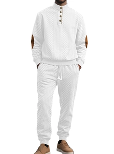 Detail of white knit tracksuit featuring stand collar buttons and brown elbow patches