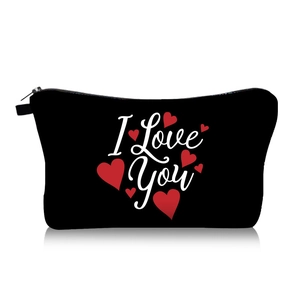 Detail of a black canvas makeup bag with I Love You text and red heart patterns