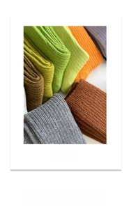 Detail of ribbed knit wool socks showing thick texture in vibrant autumn colors