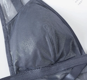 Detail of grey mesh fabric with elastic hem and professional zigzag stitching on bra