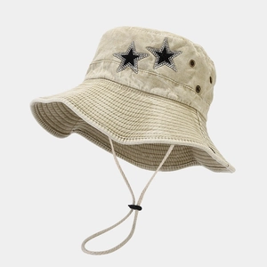 Close-up of rhinestone star accents and adjustable windproof cord on a washed cotton sun hat