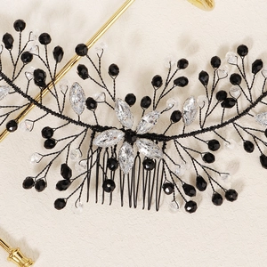 Detail of bridal hair comb with crystal flowers and black beaded wire branches
