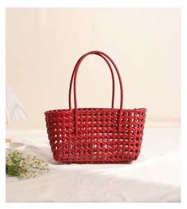 Detail of red hollowed-out woven tote bag with plastic mesh design for beach vacation