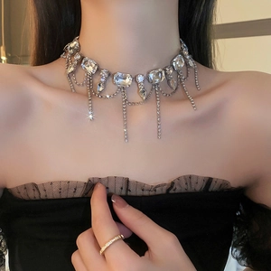 Close-up of elegant silver rhinestone fringe necklace with teardrop crystals on model