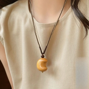 Minimalist wooden crescent moon pendant necklace with two-tone woven rope on model