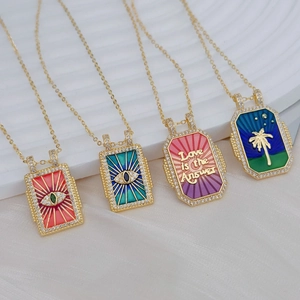 Vintage gold tarot card necklaces with colorful enamel evil eye and palm tree pendants