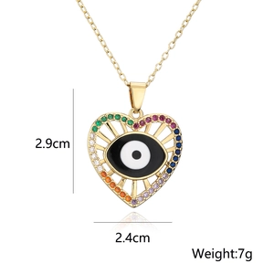 Detailed view of gold heart pendant with evil eye and rainbow zircons, 2.9cm by 2.4cm